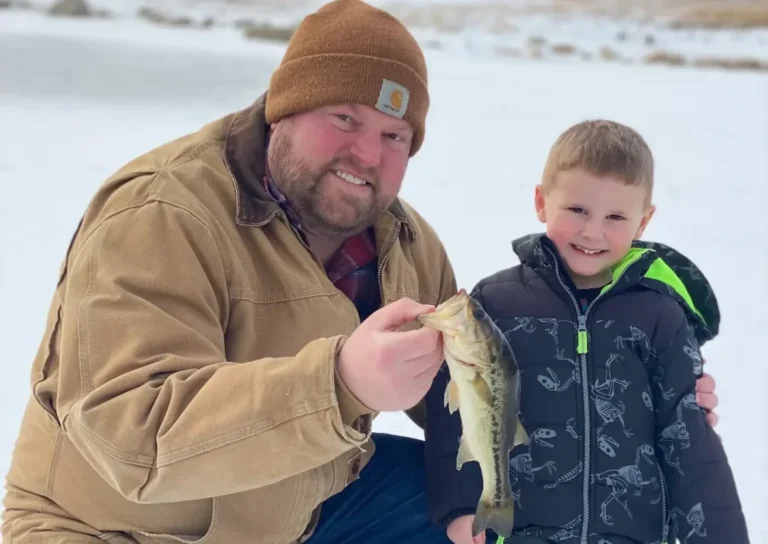 Aaron Drendel ice fishing with his son on an Illinois pond — Find Boat Services founder and Midwest boating expert