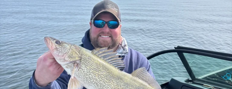 Angler holding a walleye caught on Lake Michigan
