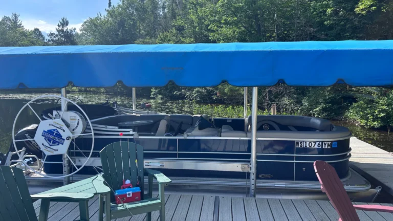 Family pontoon boat tied up at a lake dock in Wisconsin